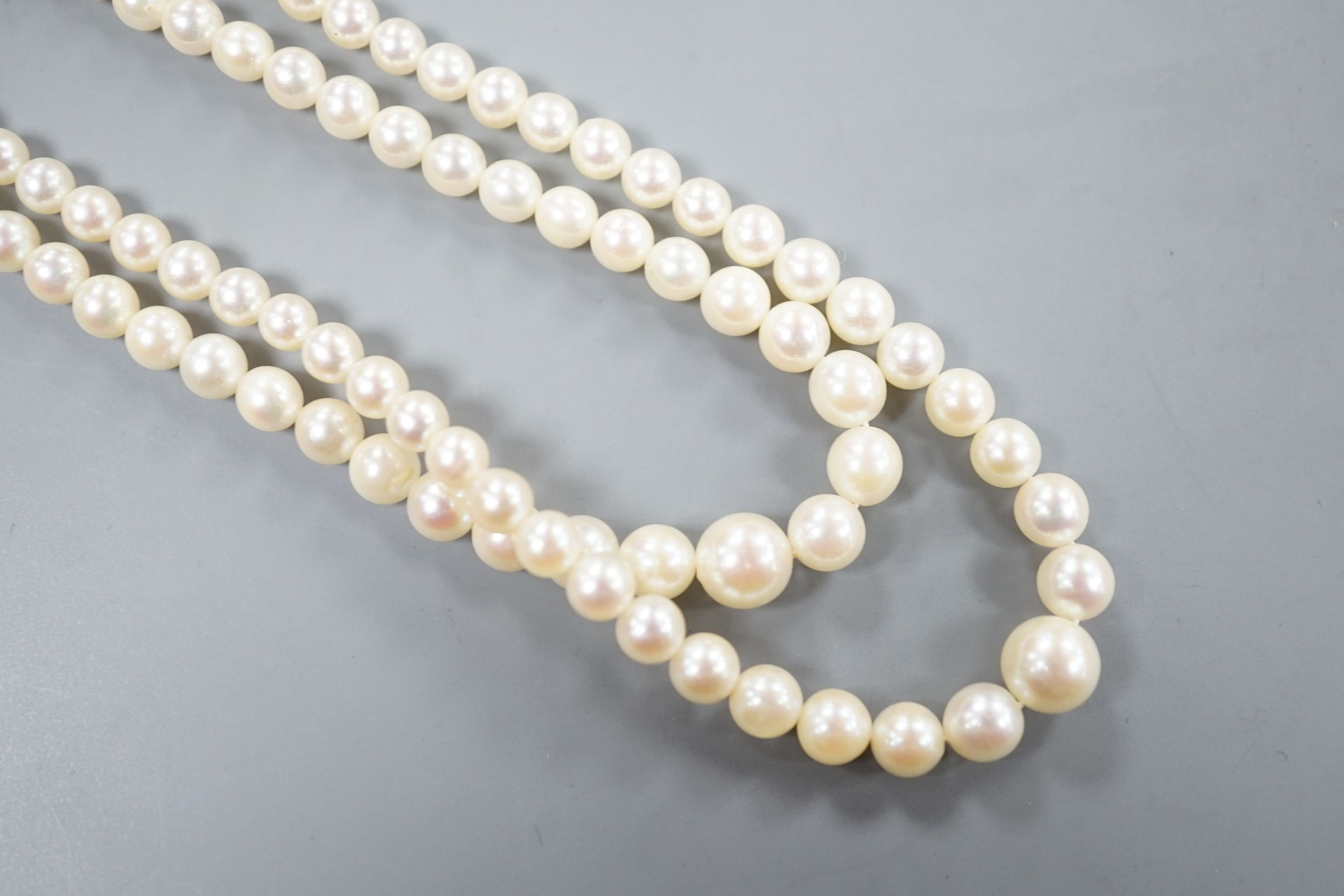 A double strand graduated cultured pearl necklace, with a 9ct and cultured pearl set clasp, 44cm.